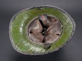 a close up of a green hat with a hole in the middle