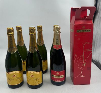 six bottles of champagne are lined up in a row next to a red box