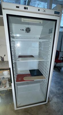 an empty refrigerator in the middle of a room