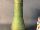 two green vases sitting next to each other on a table