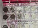 a lot of coins in a red box on a table