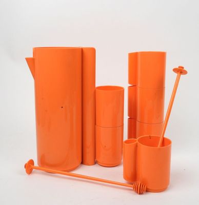 a group of orange vases and cups on a white background