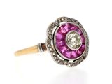 a close up of a pink and white diamond ring on a white background