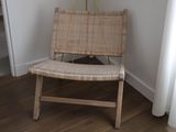 a wicker chair in the corner of a room