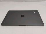 the back of an apple laptop computer sitting on top of a white surface
