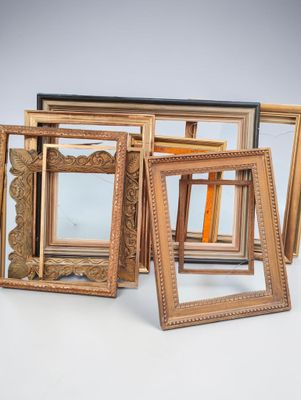 a lot of picture frames sitting on a table
