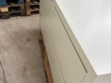 a picture of a white dresser in a warehouse