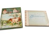 un vieux livre avec l'image de deux vaches dans un champ