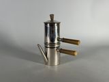 a silver coffee pot with two wooden handles on a white surface