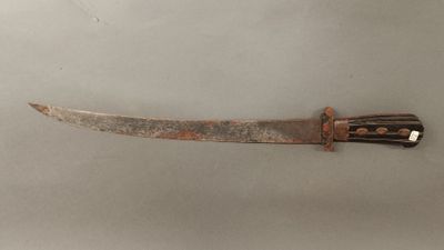 a close up of a knife on a table with a white background