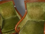 pair of green upholstered chairs with wood arms and arms