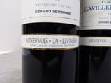 two bottles of wine that are sitting on a table