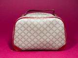 a close up of a white and red bag on a pink surface