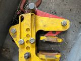 a yellow pipe clamp sitting in a metal box