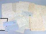 several old papers are piled on top of each other on a table