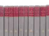 six books in a row on a white surface