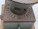 an old machine that is sitting on top of a wooden block