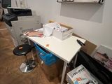 a desk with a printer and a chair in a room