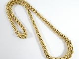 a gold rope necklace with a clasp on a white background