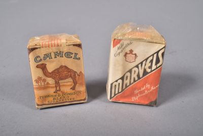 two boxes of camel cigarettes sitting next to each other on a table