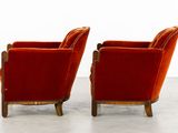 pair of red velvet club chairs with gold trim