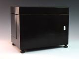 a small black cabinet with a drawer on wheels