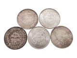 six different types of silver coins on a white background