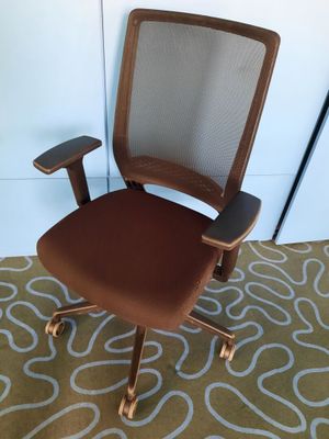an image of a brown office chair on a rug in a room