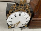 a clock that is sitting on the floor next to a door