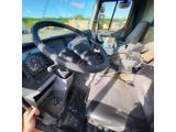 a driver ' s seat and steering wheel of a truck