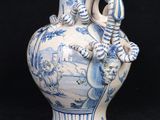a blue and white vase with a dragon on it