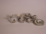 a lot of small cups and saucers sitting on a table