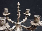 a silver candelab with three candles on it
