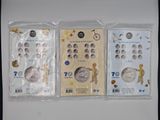three different types of coins are in plastic bags on a table