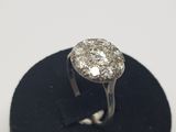 an image of a diamond ring on a black stand