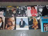 a bunch of different albums and cds on the floor