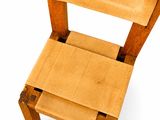 a small chair made out of cardboard on a white surface