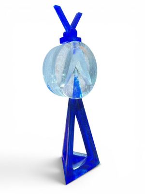 a blue glass object with a blue ribbon on it