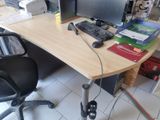 a desk with a computer, keyboard, mouse, and other items on it