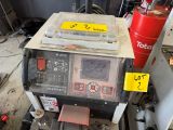 a machine that is sitting on a table in a garage