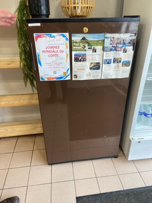 a small refrigerator with a lot of information on it