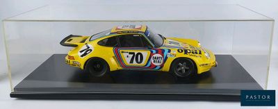 display case with a yellow car in it on a black base