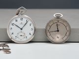 two clocks sitting next to each other on a table