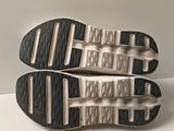 the soles of a pair of running shoes on a white surface