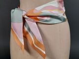 an image of a mannequin torso with a colorful scarf tied to it