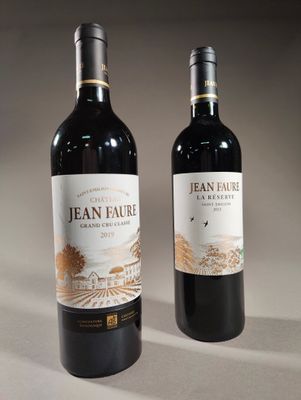 two bottles of wine sitting next to each other on a table