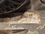 a rusted piece of metal on the floor of a room