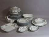a lot of plates and bowls that are sitting on a table