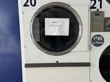 a washing machine with a sign on the front of it