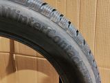 tire on the floor next to a cardboard box with a cardboard box in the background